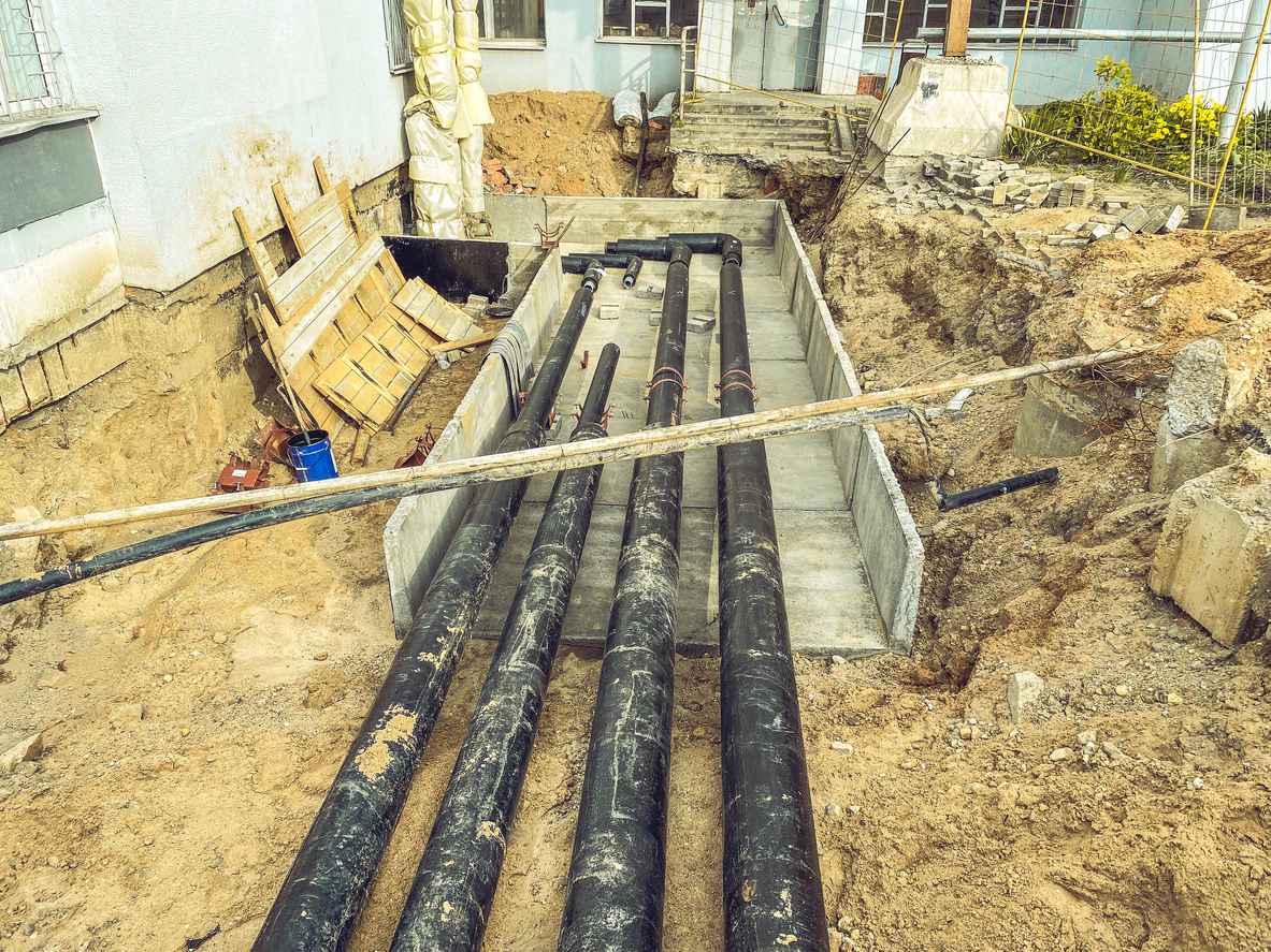 black, polypropylene, long pipes are laid underground for communications. underground communications with water for residential buildings.