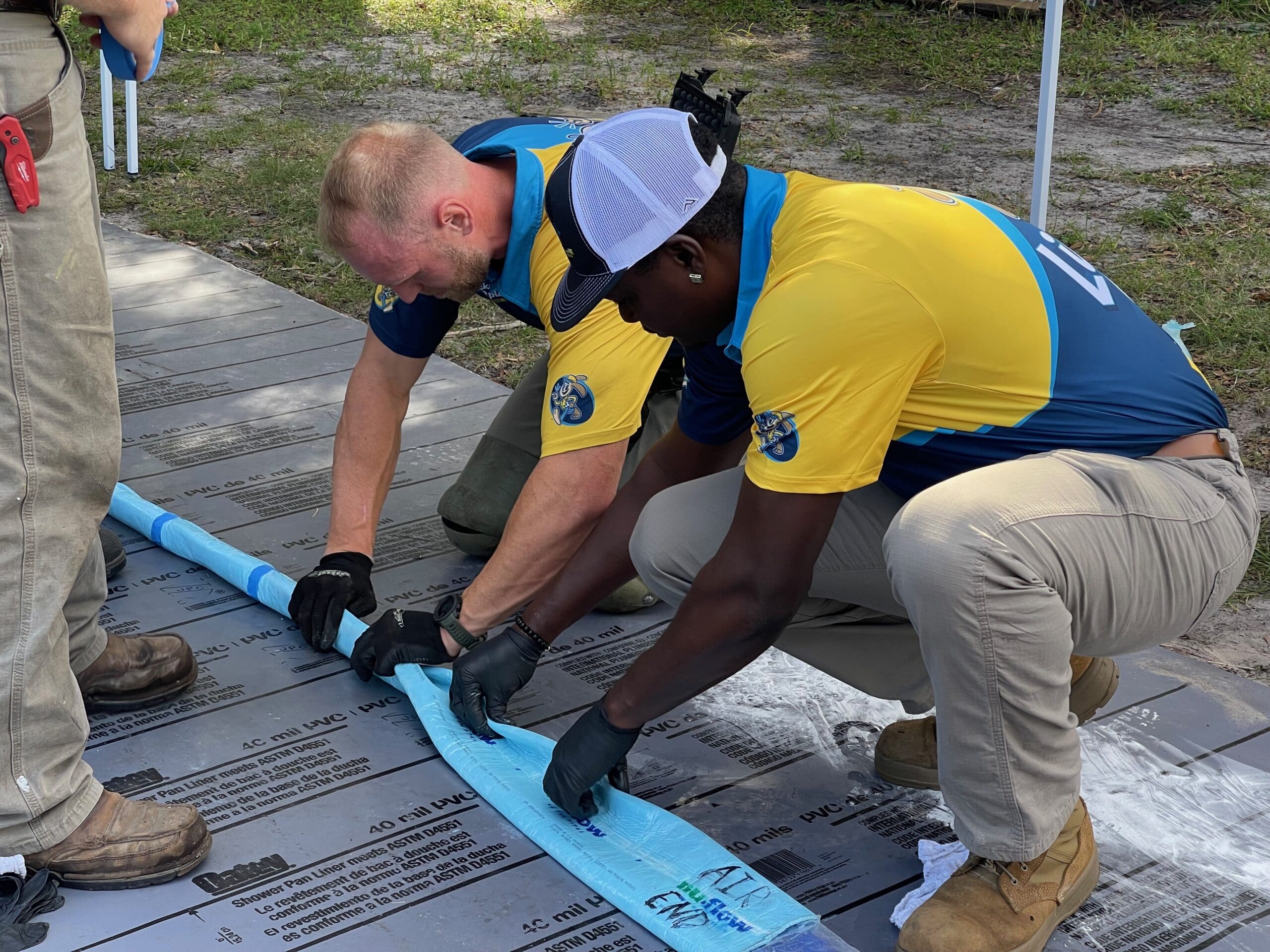 Employees of Lickety-Split Performing a Pipe Lining Job