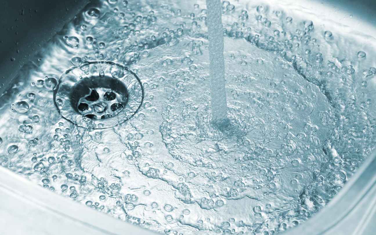 Running water in stainless kitchen sink