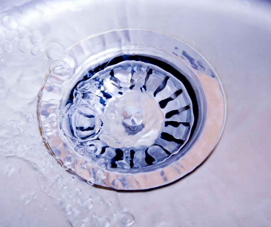 water flowing into a drain in a sink