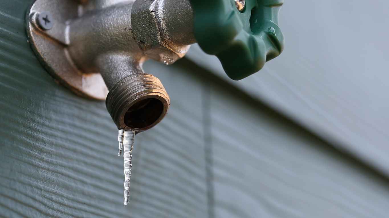 Outdoor pipe with icicle hanging from it