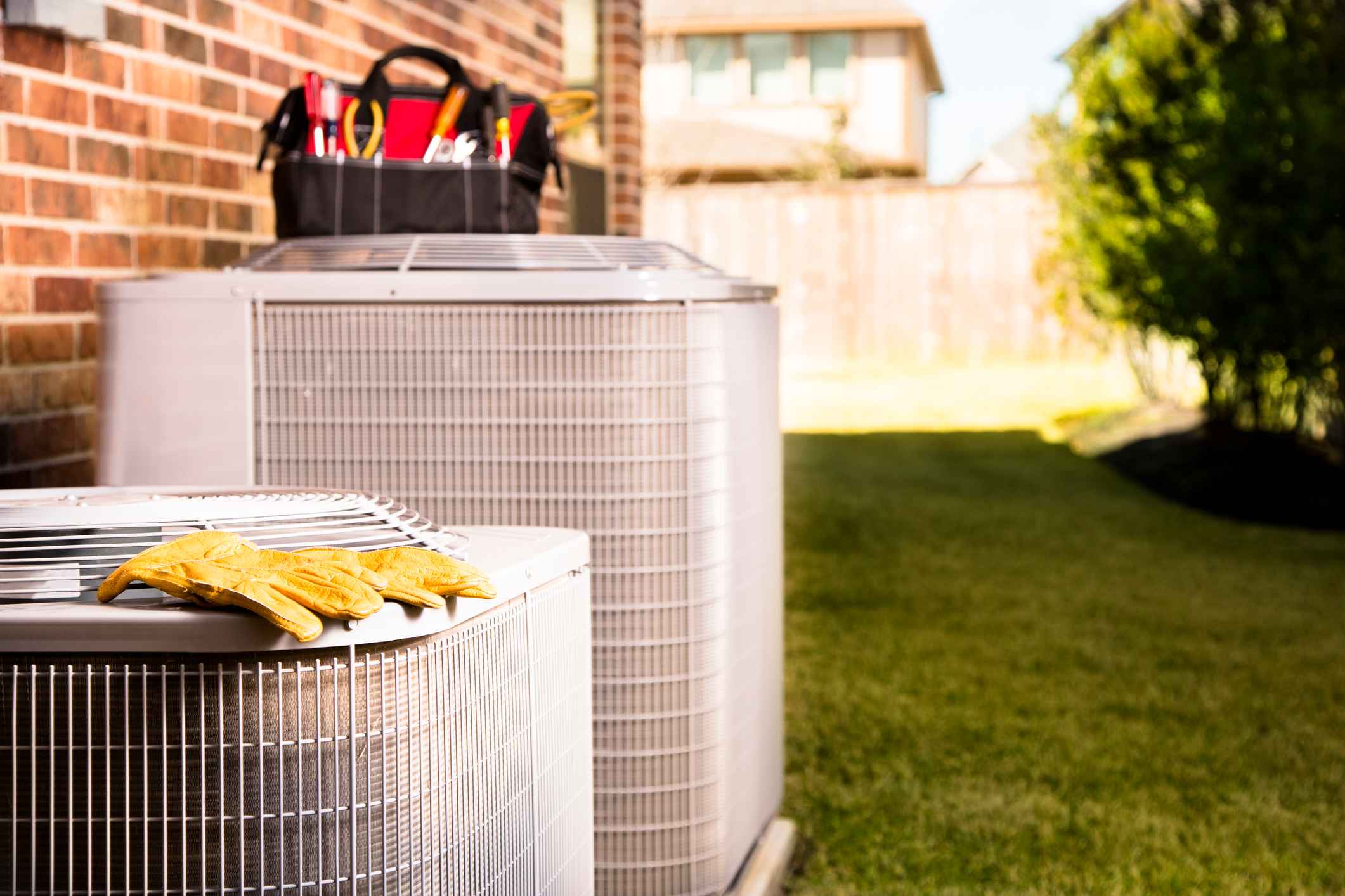 An outdoor HVAC system with technician's tools on the unit to perform maintenance