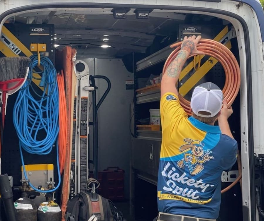 Plumber Preparing Equipment from Van for Water Treatment Services